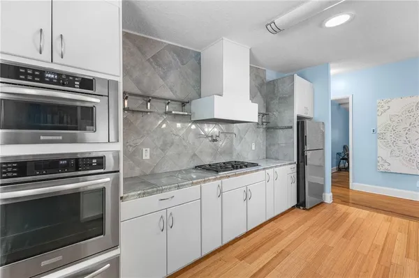 a kitchen with stainless steel appliances granite countertop a stove and a refrigerator