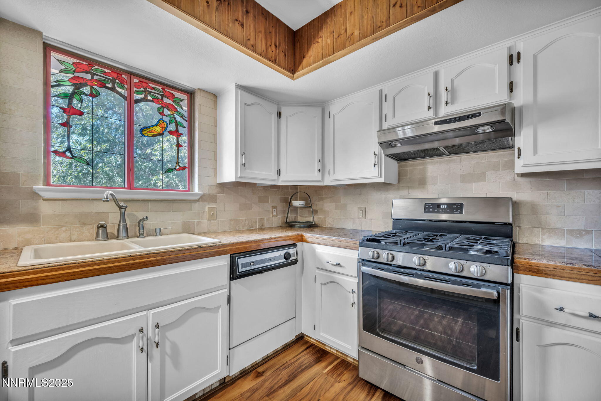 15333 Kivett Lane Reno, NV 89521 - Photo 12 of 38 a kitchen with stainless steel appliances granite countertop a stove a sink and a microwave