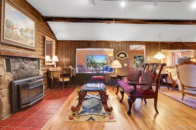 a living room with fireplace furniture and a large window