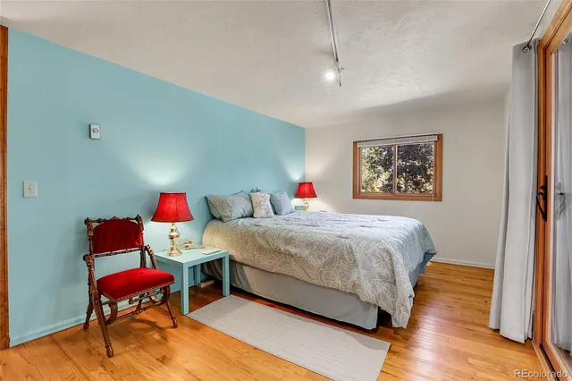 a bedroom with a bed and a bookshelf