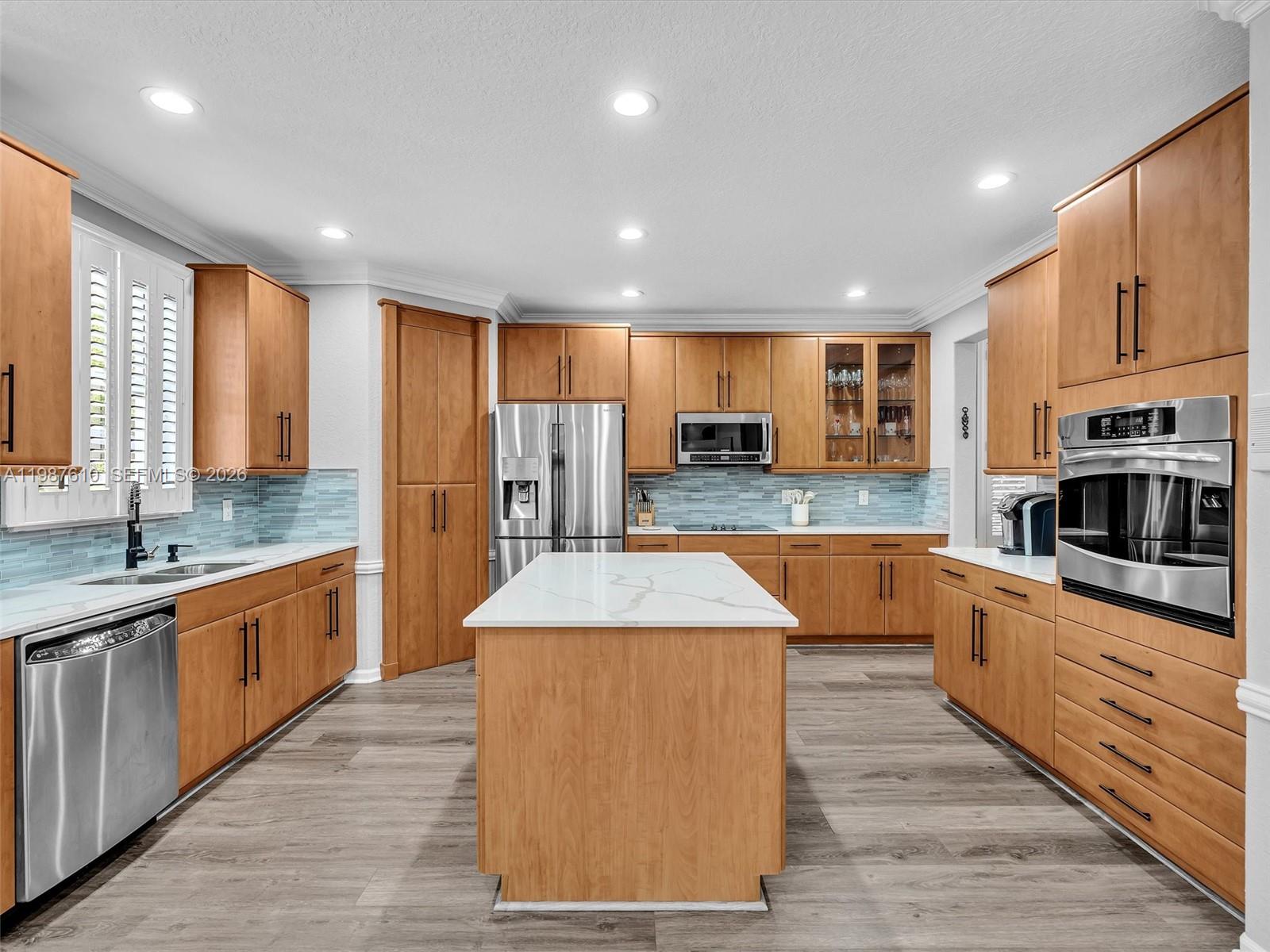 8878 Cobblestone Point Circle Boynton Beach, FL 33472 - Photo 15 of 89 a large kitchen with stainless steel appliances granite countertop a large counter top and a stove