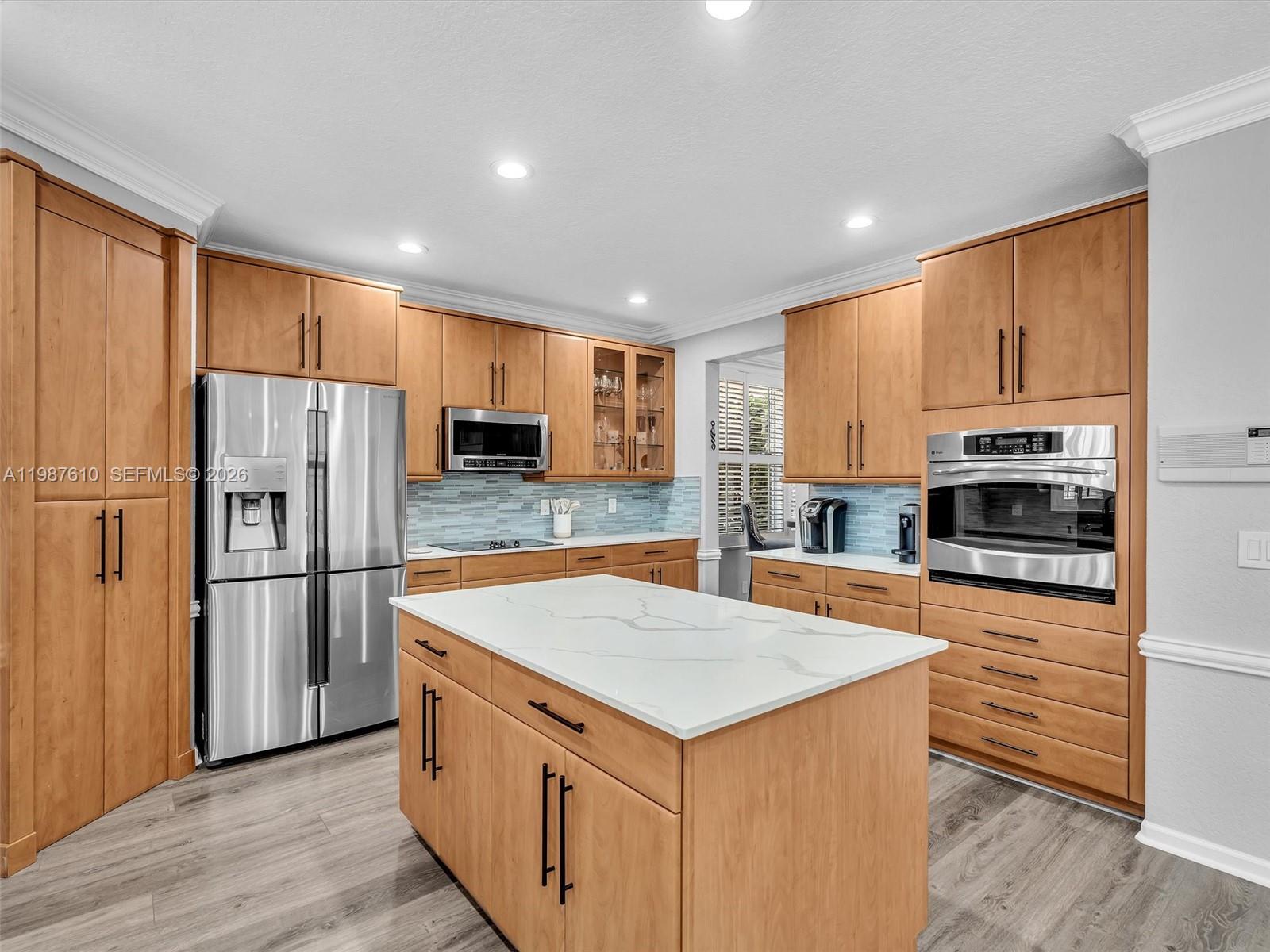 8878 Cobblestone Point Circle Boynton Beach, FL 33472 - Photo 17 of 89 a kitchen with stainless steel appliances a refrigerator and a stove top oven