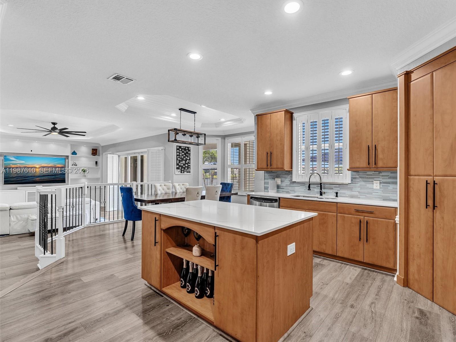 8878 Cobblestone Point Circle Boynton Beach, FL 33472 - Photo 19 of 89 a kitchen with stainless steel appliances granite countertop a sink a stove and a wooden floors