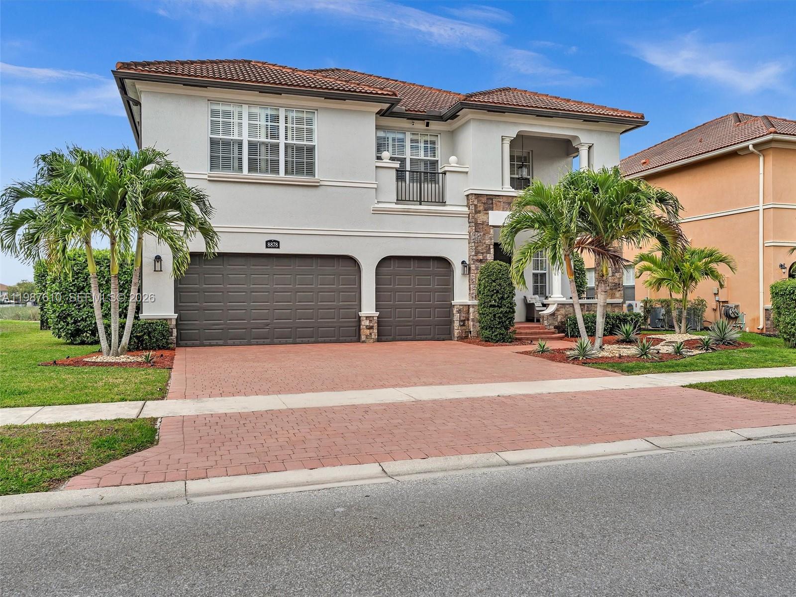 8878 Cobblestone Point Circle Boynton Beach, FL 33472 - Photo 2 of 89 a front view of a house with a yard and garage
