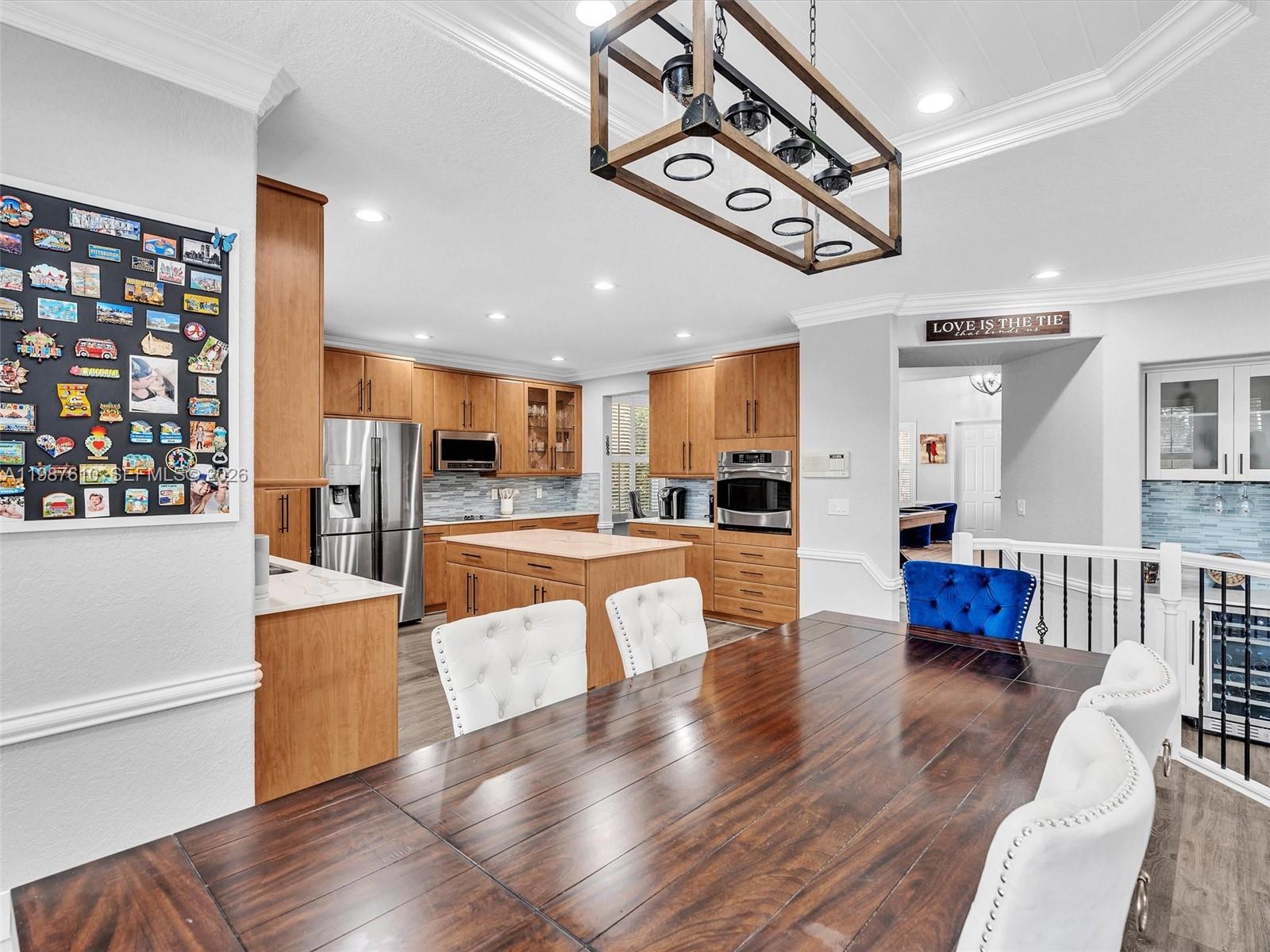 8878 Cobblestone Point Circle Boynton Beach, FL 33472 - Photo 22 of 89 a view of kitchen with stainless steel appliances refrigerator stove and wooden floor