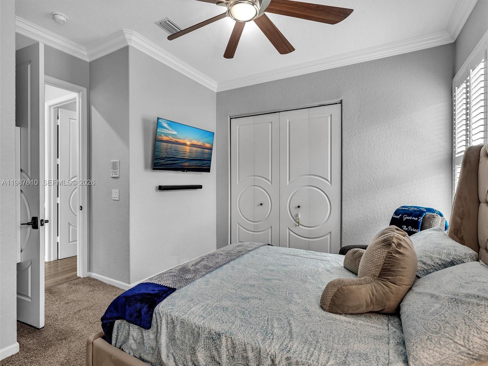 8878 Cobblestone Point Circle Boynton Beach, FL 33472 - Photo 34 of 89 a bedroom with a bed and a chandelier
