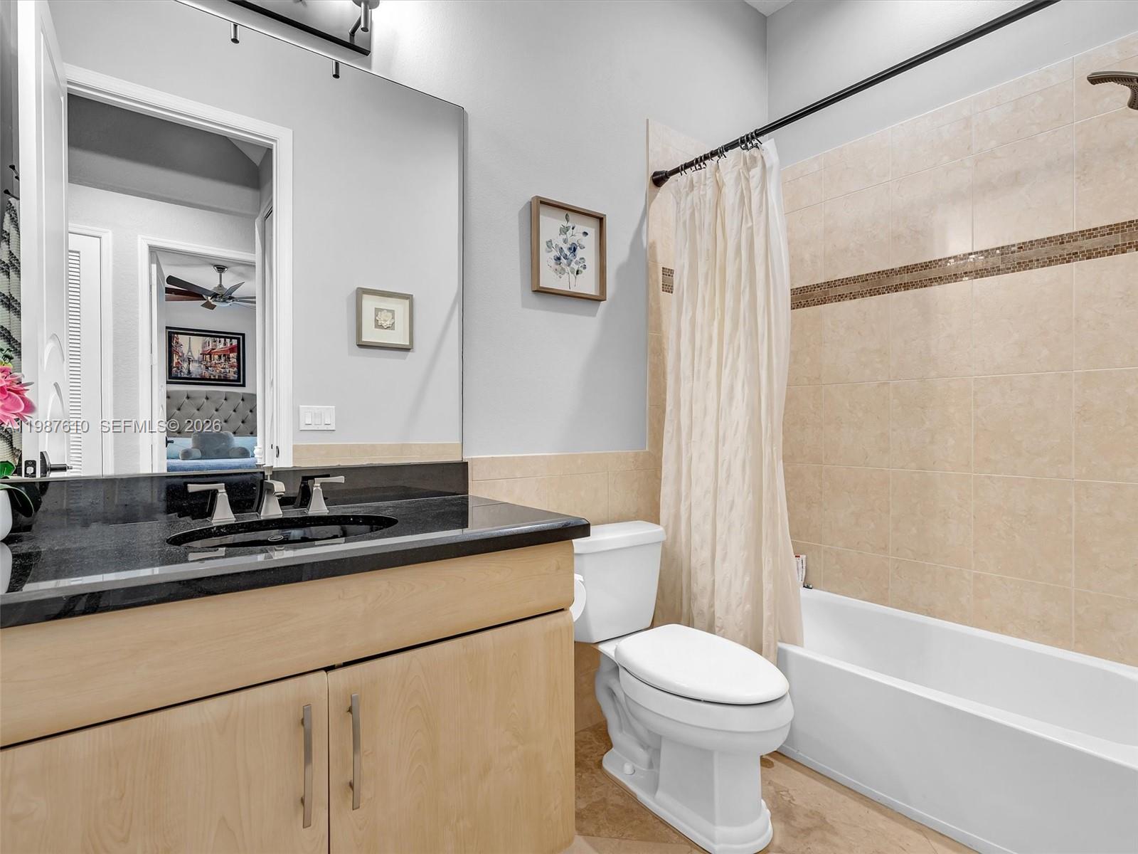8878 Cobblestone Point Circle Boynton Beach, FL 33472 - Photo 36 of 89 a bathroom with a granite countertop sink mirror vanity and toilet