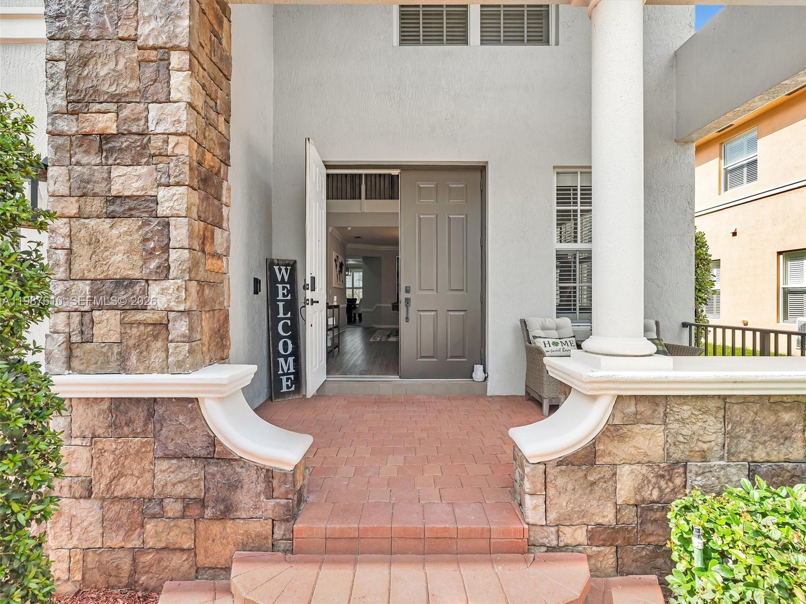 8878 Cobblestone Point Circle Boynton Beach, FL 33472 - Photo 6 of 89 a view of a patio with table and chairs and potted plants