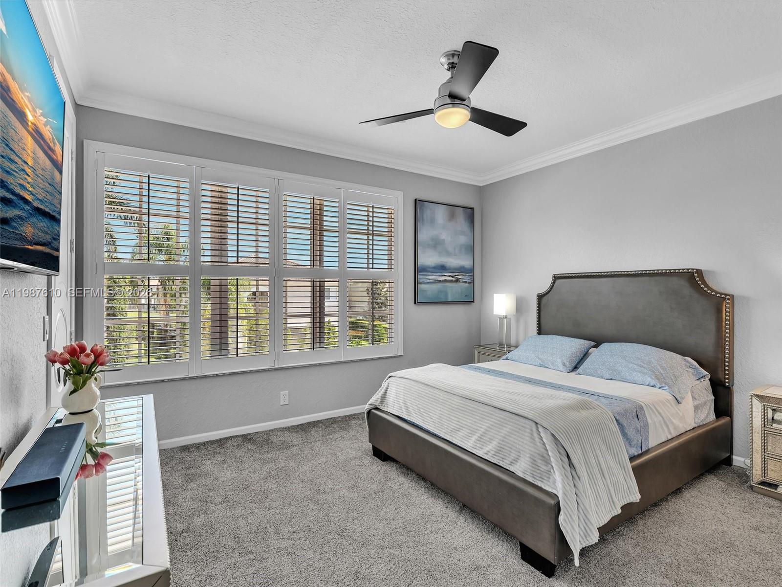 8878 Cobblestone Point Circle Boynton Beach, FL 33472 - Photo 69 of 89 a spacious bedroom with a bed and a large window