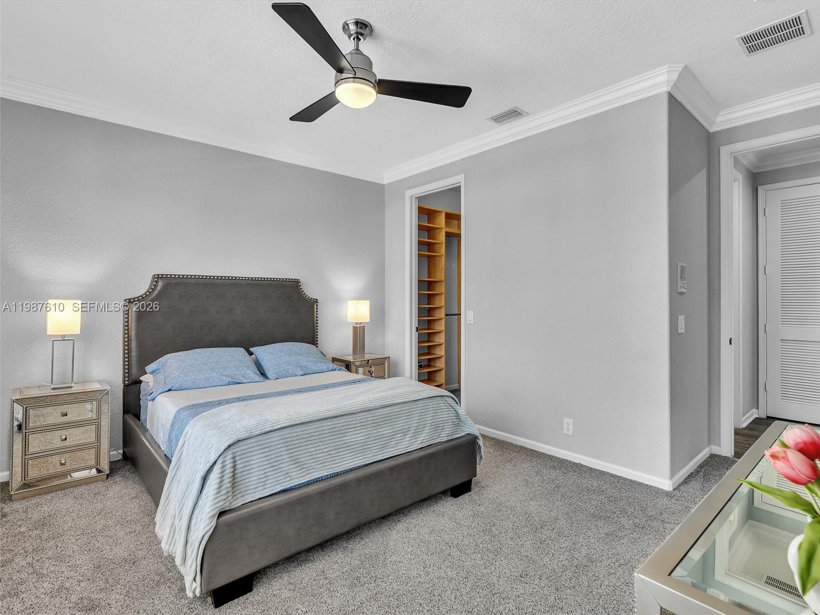 8878 Cobblestone Point Circle Boynton Beach, FL 33472 - Photo 70 of 89 a bedroom with a bed and a ceiling fan