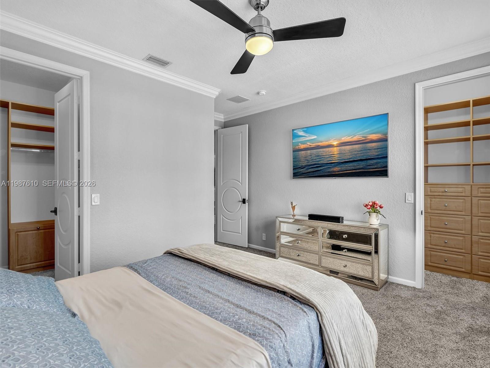 8878 Cobblestone Point Circle Boynton Beach, FL 33472 - Photo 71 of 89 a bedroom with bed and a flat tv screen on dresser