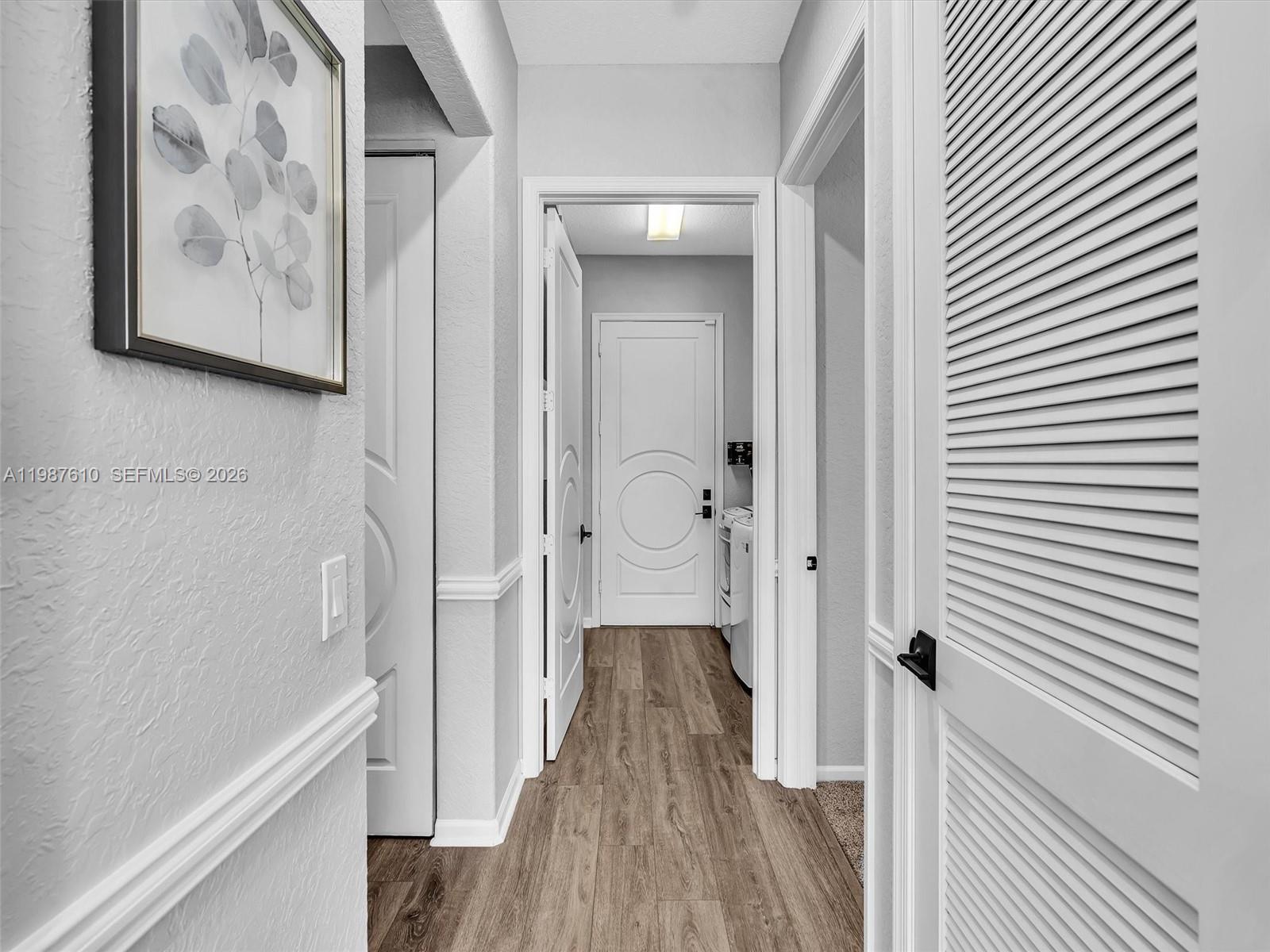 8878 Cobblestone Point Circle Boynton Beach, FL 33472 - Photo 75 of 89 a view of a hallway with wooden floor and closet