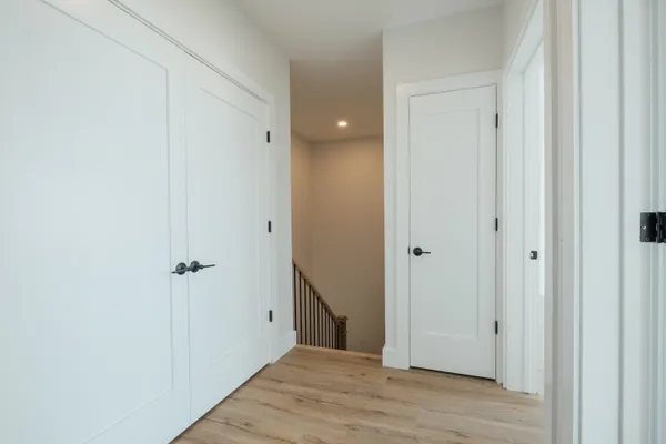a view of a hallway with wooden floor