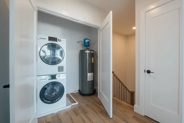 a view of a bedroom with washer and dryer