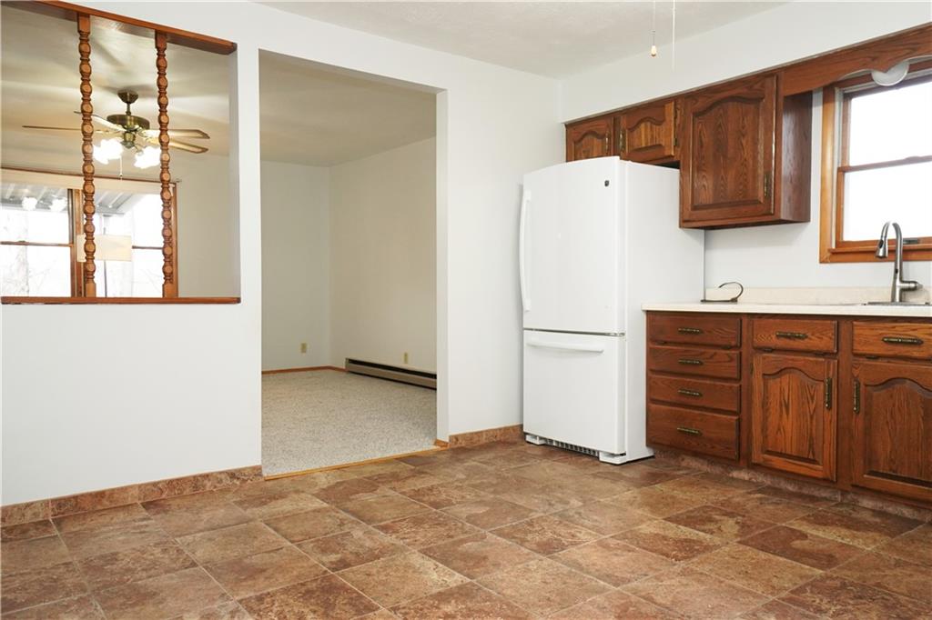 243 Gaskill Road Grindstone, PA 15442 - Photo 8 of 17 a view of a kitchen with wooden cabinet and a sink