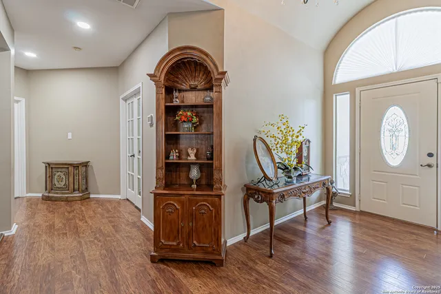 a kitchen with kitchen island granite countertop a sink a counter top space appliances and cabinets