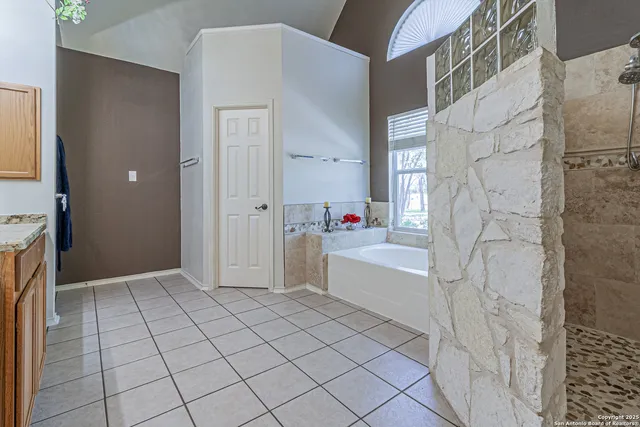 an aerial view of a house with a yard and lake view