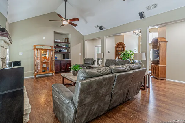 a living room with furniture a fireplace and a flat screen tv