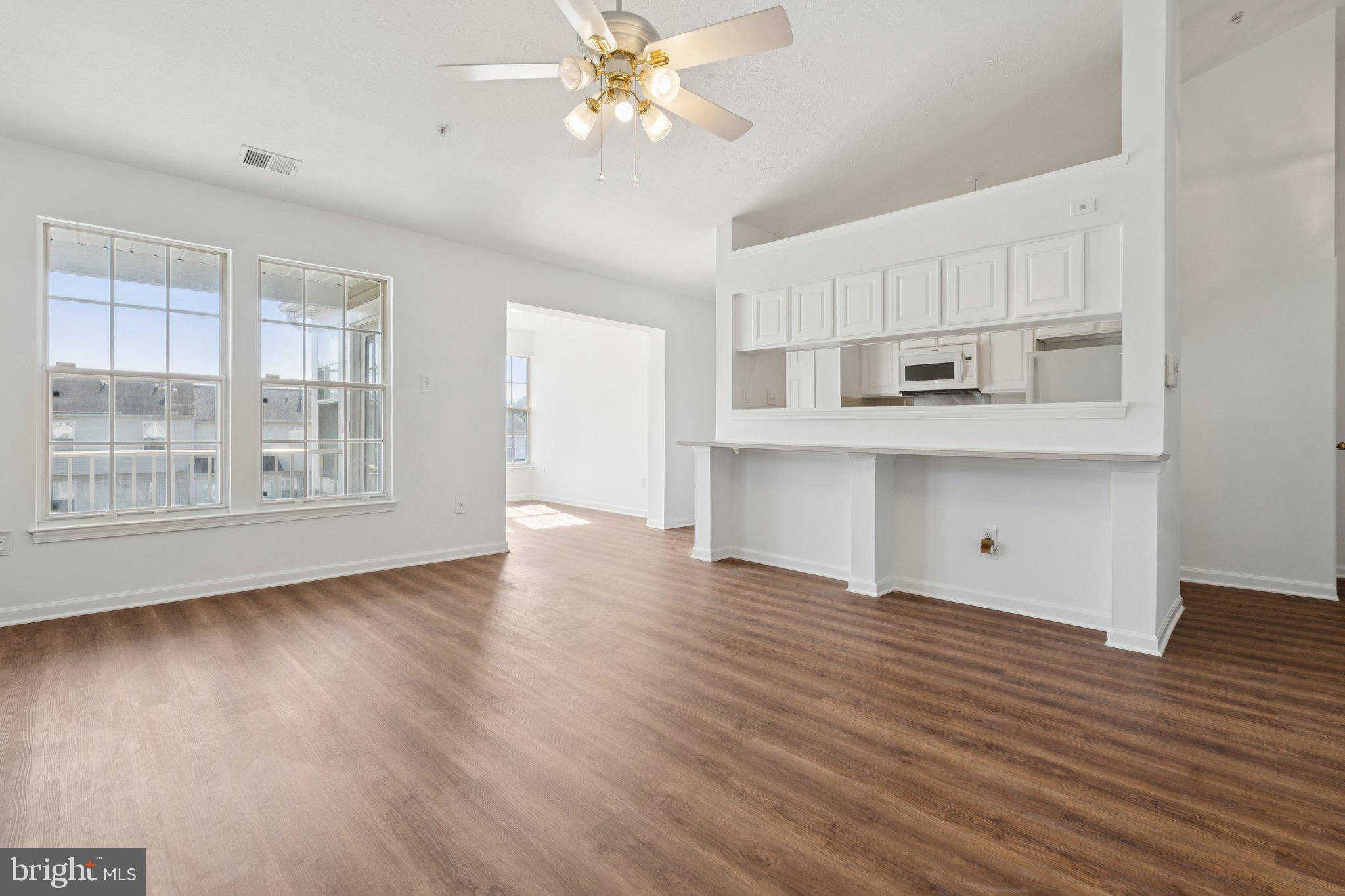 a view of kitchen with workspace and wooden floor