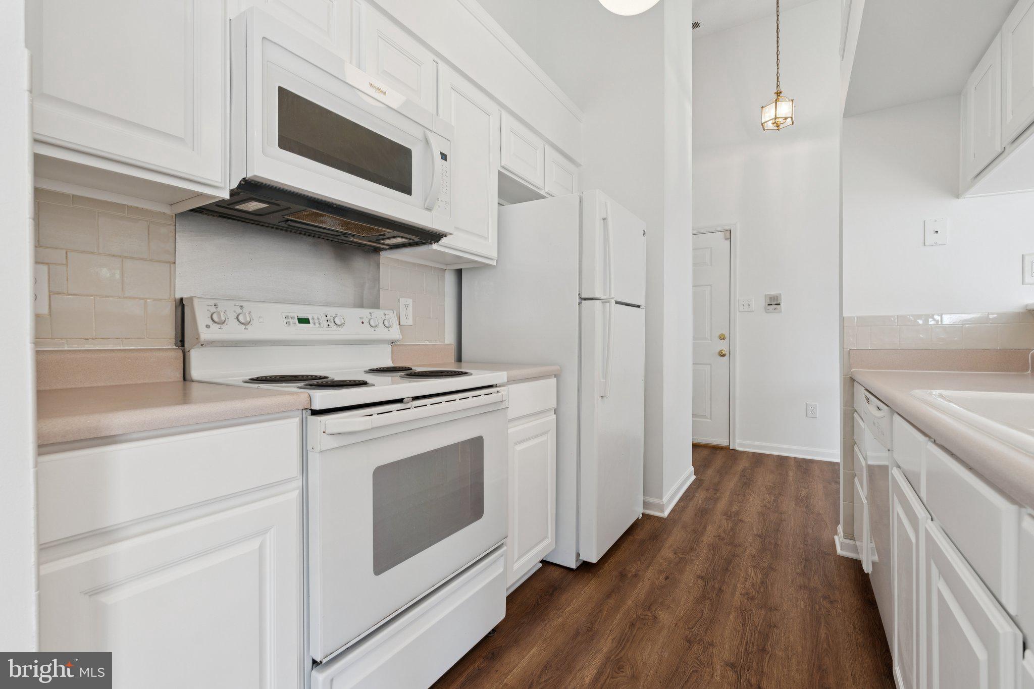 7655 Gladstone Road, Unit 5 Baltimore, MD 21244 - Photo 11 of 25 a kitchen with stainless steel appliances white cabinets and a stove