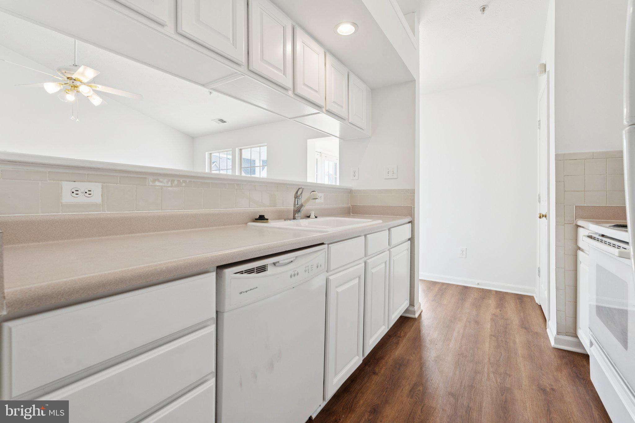 7655 Gladstone Road, Unit 5 Baltimore, MD 21244 - Photo 12 of 25 a kitchen with a sink cabinets and wooden floor
