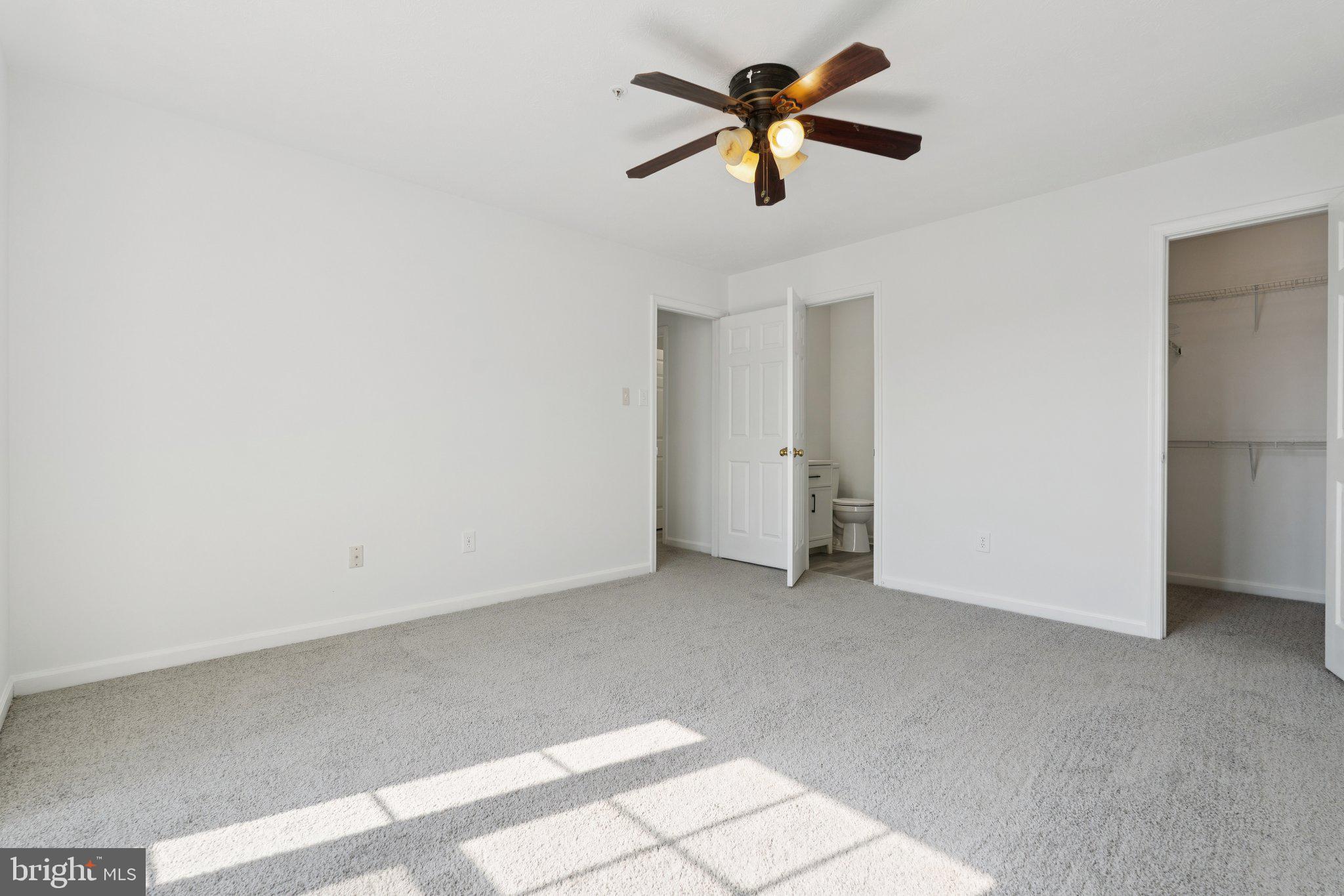 7655 Gladstone Road, Unit 5 Baltimore, MD 21244 - Photo 18 of 25 an empty room with closet and a chandelier fan