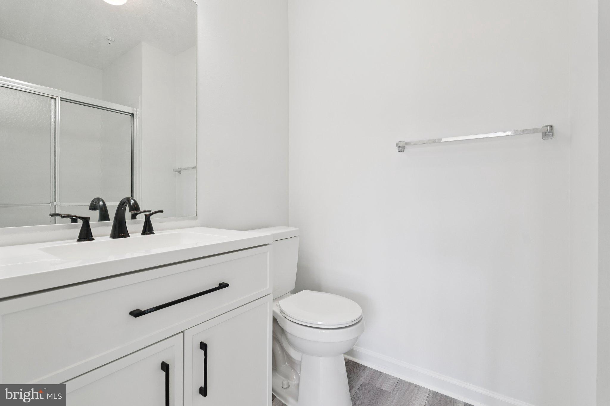 7655 Gladstone Road, Unit 5 Baltimore, MD 21244 - Photo 20 of 25 a bathroom with a sink a toilet and mirror