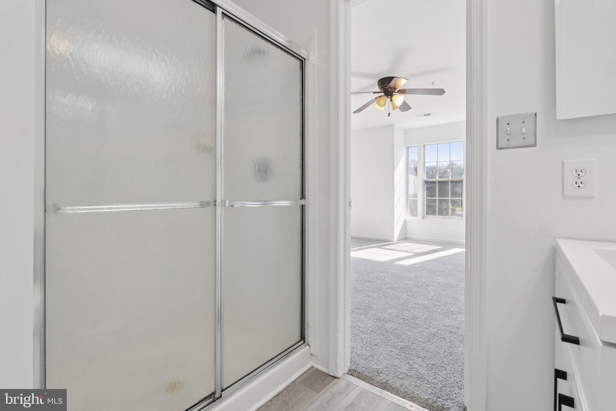 7655 Gladstone Road, Unit 5 Baltimore, MD 21244 - Photo 21 of 25 a view of a bathroom with a glass door