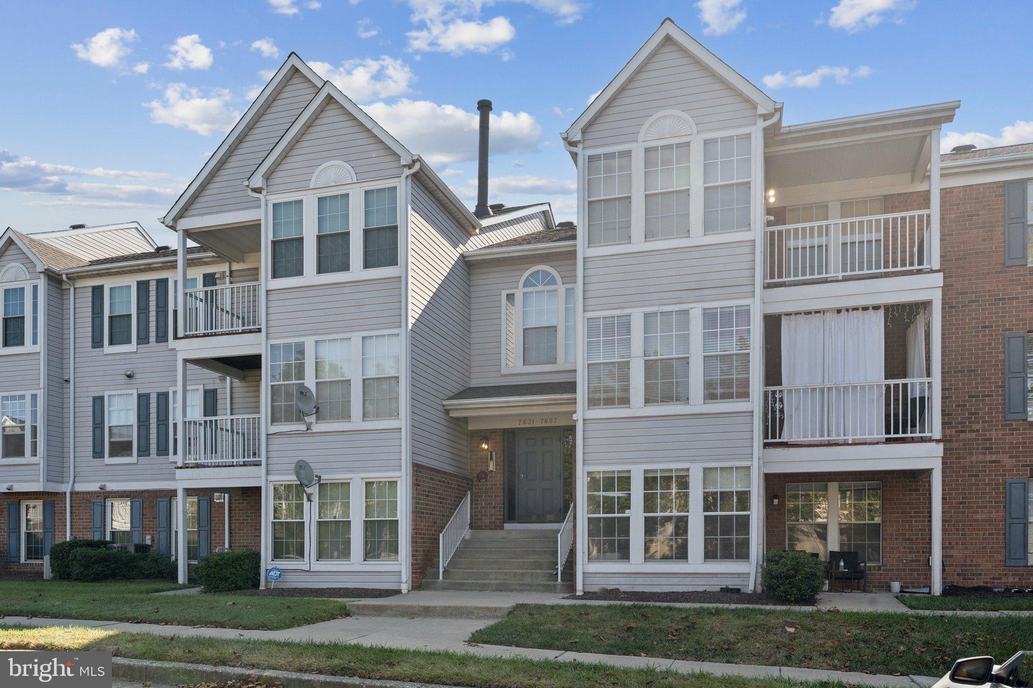 7655 Gladstone Road, Unit 5 Baltimore, MD 21244 - Photo 4 of 25 a front view of a residential apartment building with a yard