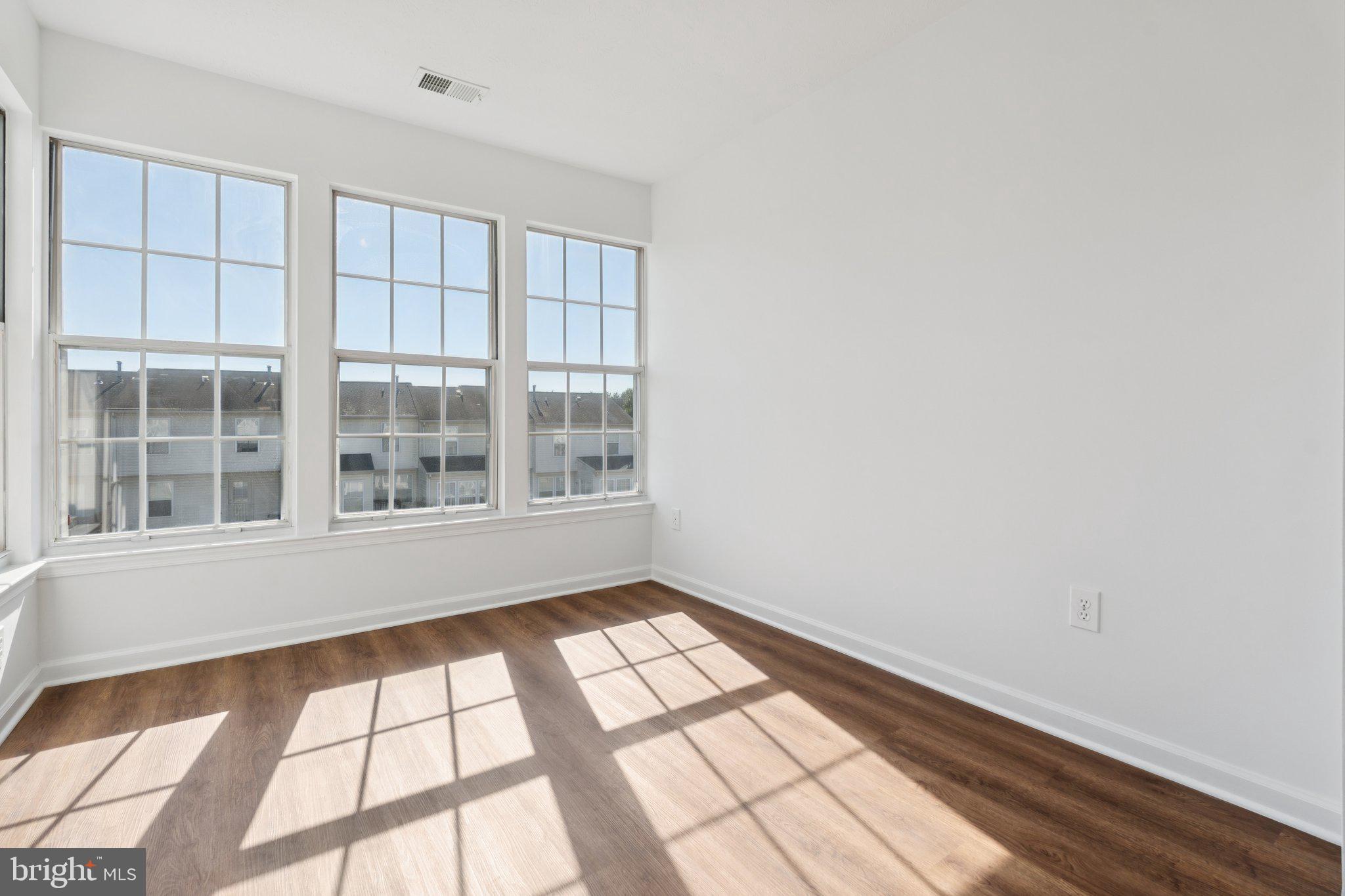 7655 Gladstone Road, Unit 5 Baltimore, MD 21244 - Photo 7 of 25 an empty room with windows