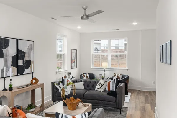a living room with furniture and a potted plant