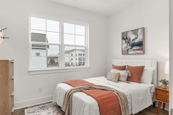 a bedroom with a bed and lamp