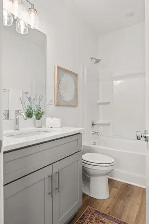 a view of a livingroom with furniture and hardwood floor