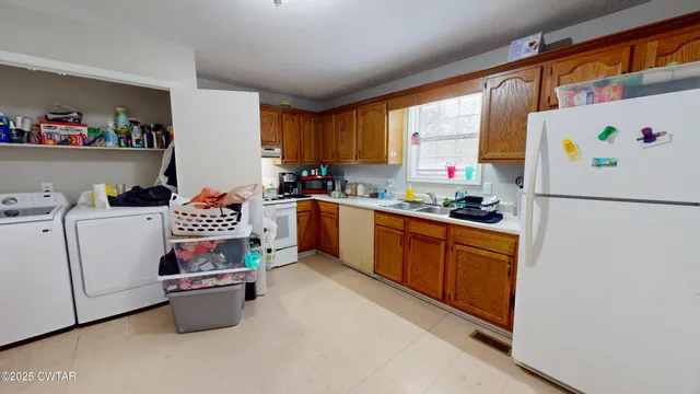a kitchen with a refrigerator and a stove