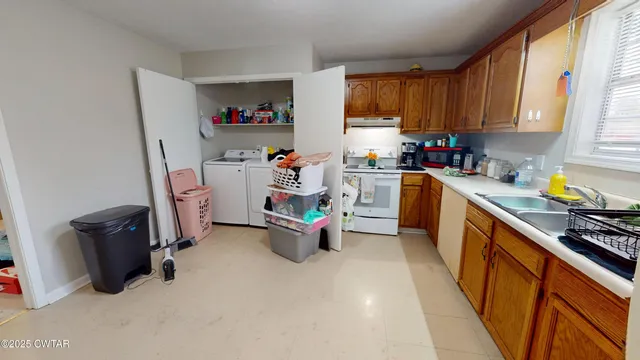 a kitchen with refrigerator and cabinets
