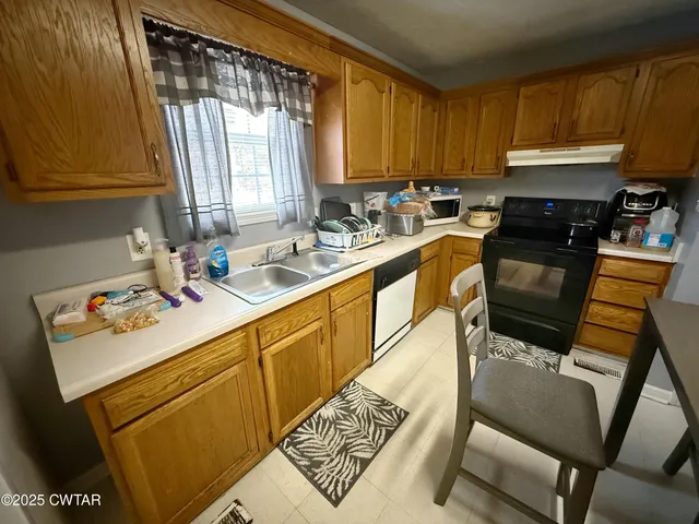 a kitchen with a sink cabinets and window