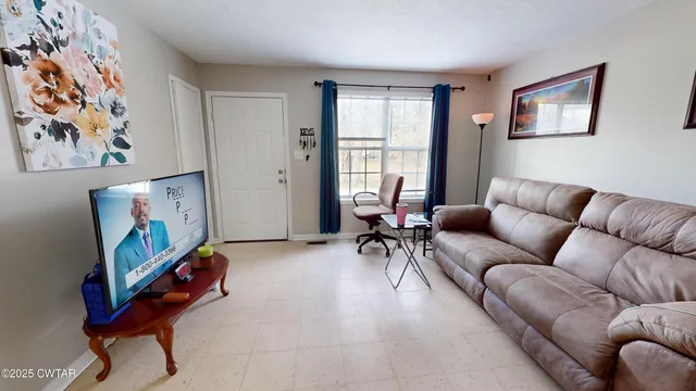 a living room with furniture a couch and paintings on the wall