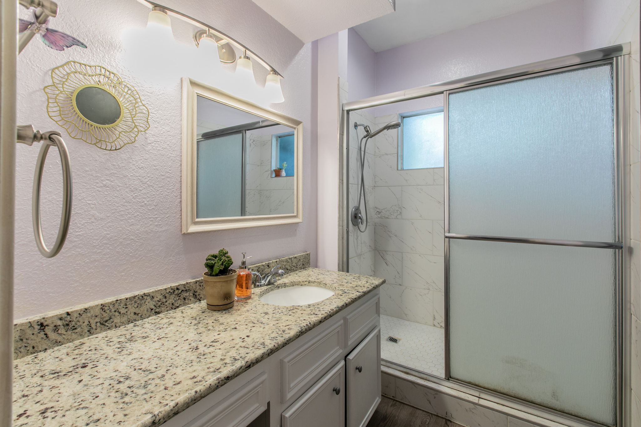 1005 North LBJ Drive, Unit B2 San Marcos, TX 78666 - Photo 9 of 19 a bathroom with a granite countertop sink and a mirror