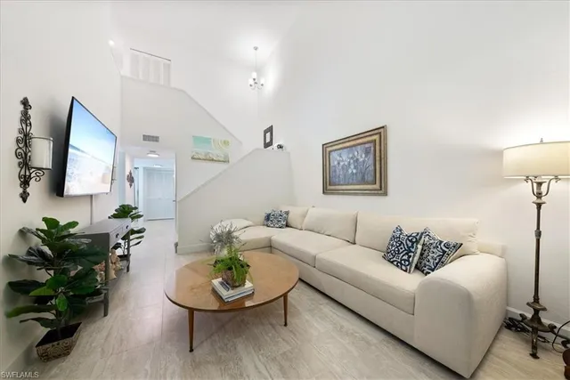 a living room with furniture and a potted plant