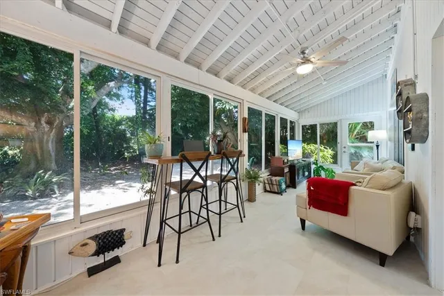 a livingroom with furniture water view and a floor to ceiling window