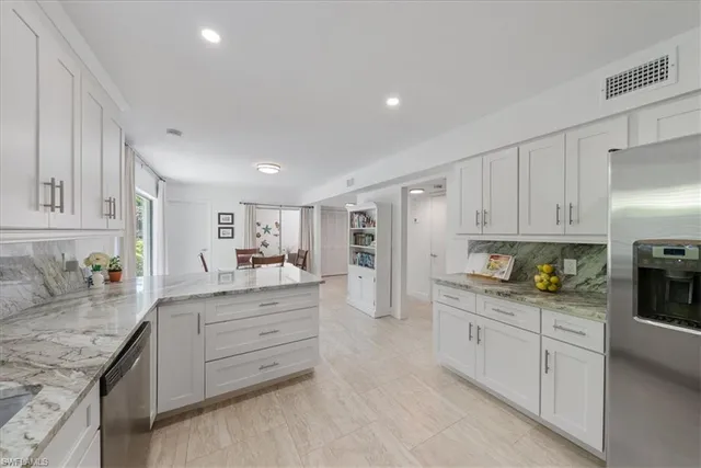 a kitchen with granite countertop a sink and cabinets