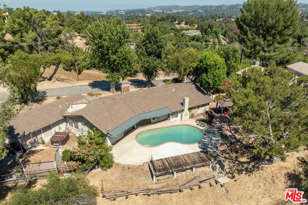 24962 Eldorado Meadow Road Hidden Hills, CA 91302 - Photo 11 of 19 an aerial view of a swimming pool and mountain view