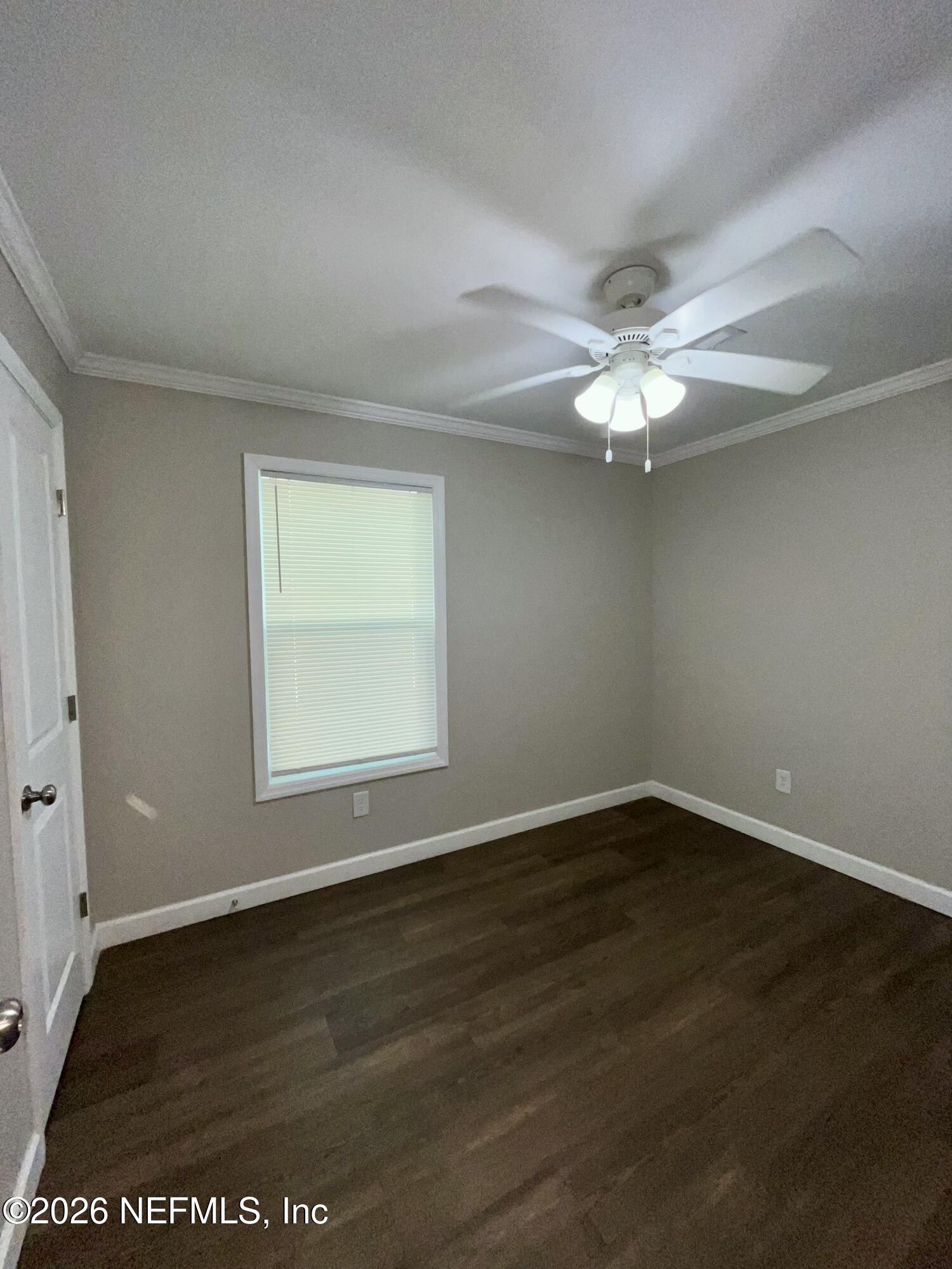 2017 Talladega Road Jacksonville, FL 32209 - Photo 29 of 34 an empty room with wooden floor and windows
