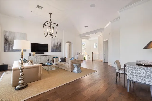 a living room with furniture wooden floor and a flat screen tv