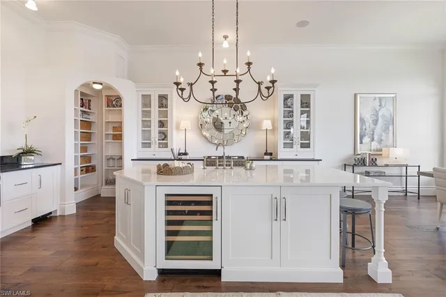 a large kitchen with cabinets and wooden floor