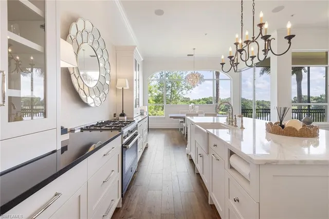 a large kitchen with kitchen island granite countertop a large window