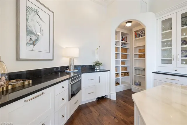 a kitchen with granite countertop a sink and cabinets