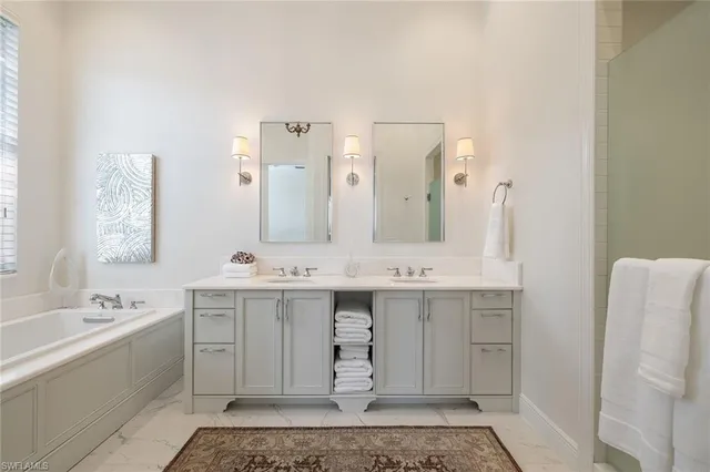 a spacious bathroom with a double vanity sink mirror and double