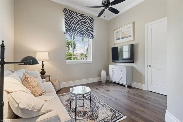 a living room with furniture a flat screen tv and a window