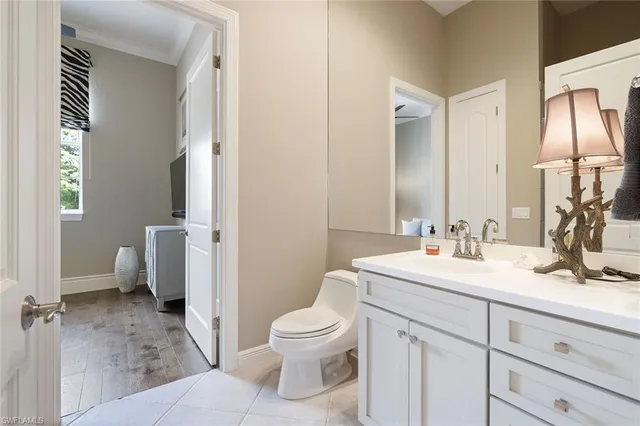 a bathroom with a toilet a sink and a mirror